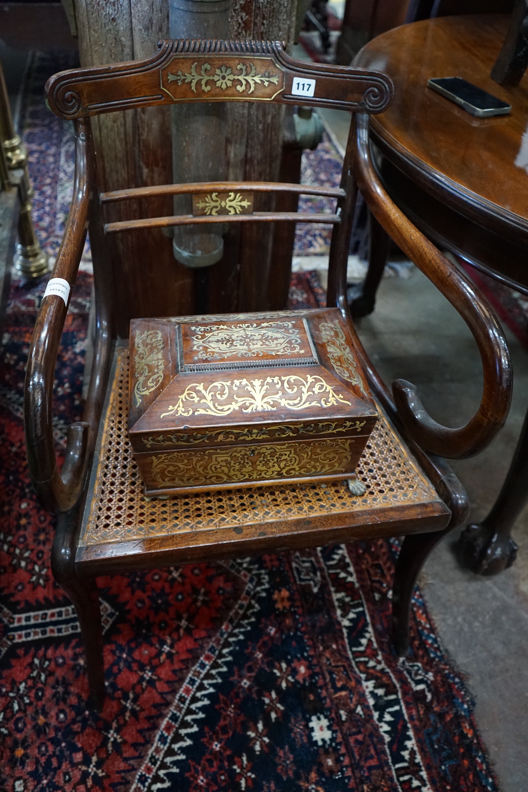 A Regency brass inlaid rosewood cane seat elbow chair together with a Regency brass inlaid work box